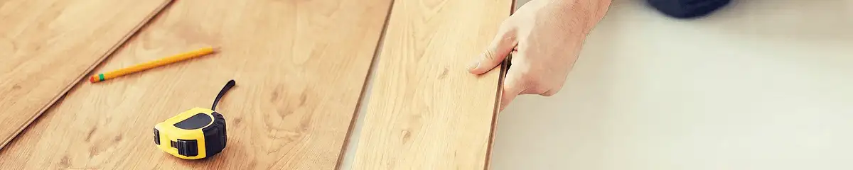 A professional installing wood flooring in Wichita, KS