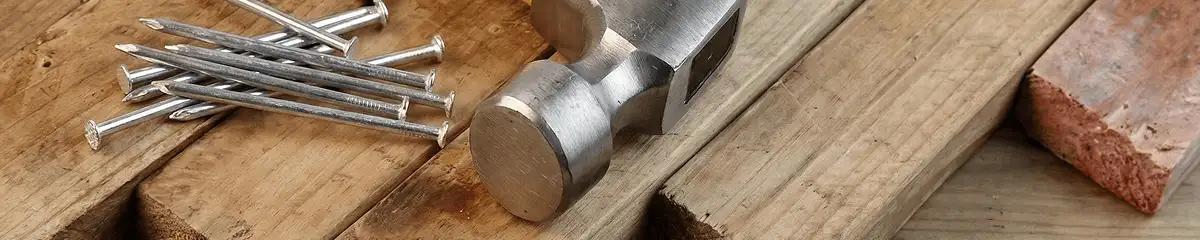 Hammer and nails on hardwood flooring boards in Wichita, KS